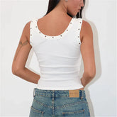 White tank top with decorative studs worn by a person